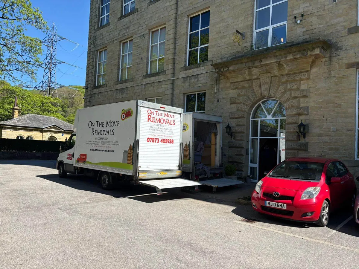 On The Move Removals van sign-written and tailgate down at a stone Victorian property in Huddersfield, real customer move on a sunny day