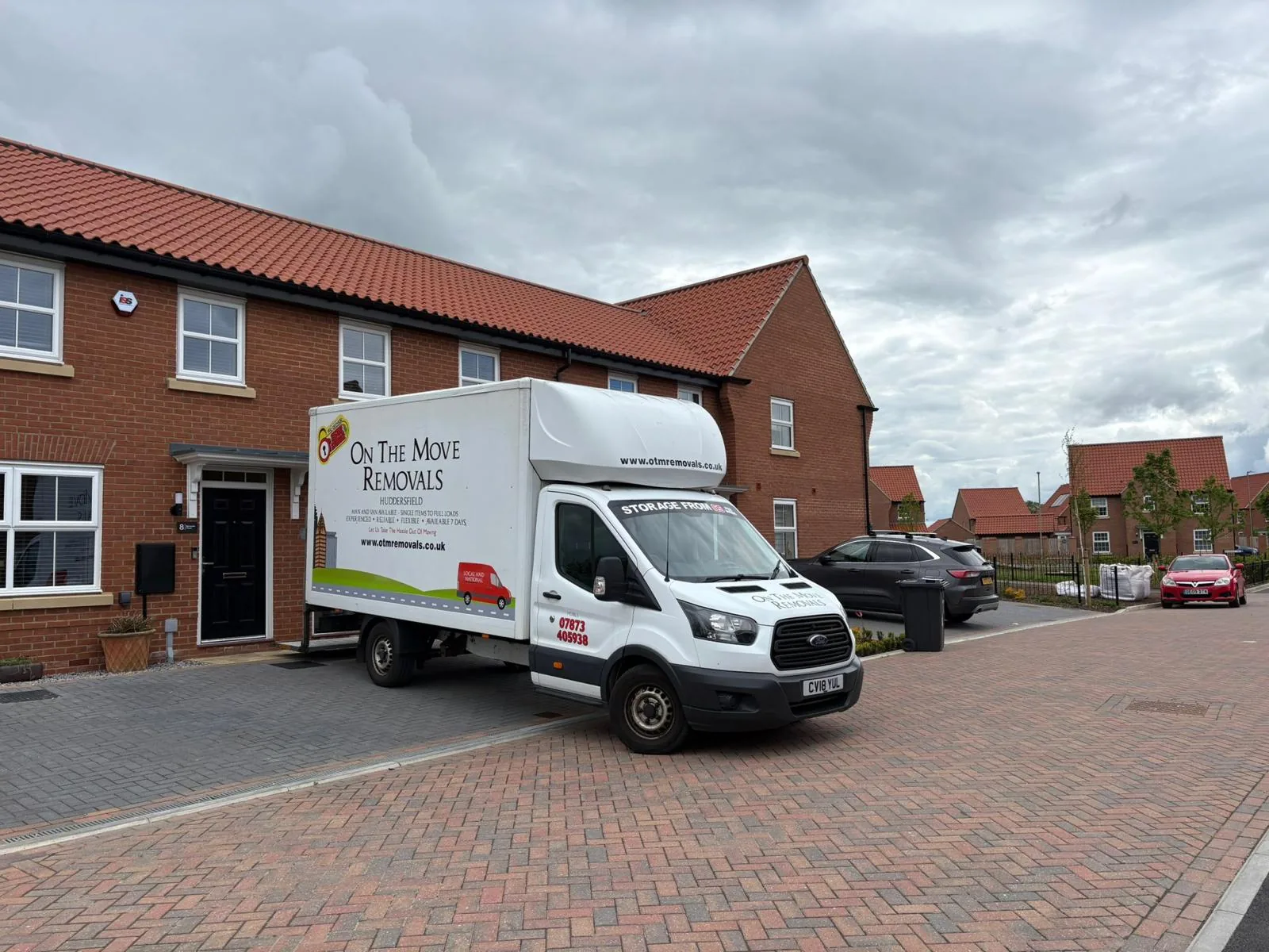 On The Move Removals Luton van on a red-brick driveway in Well House, Huddersfield