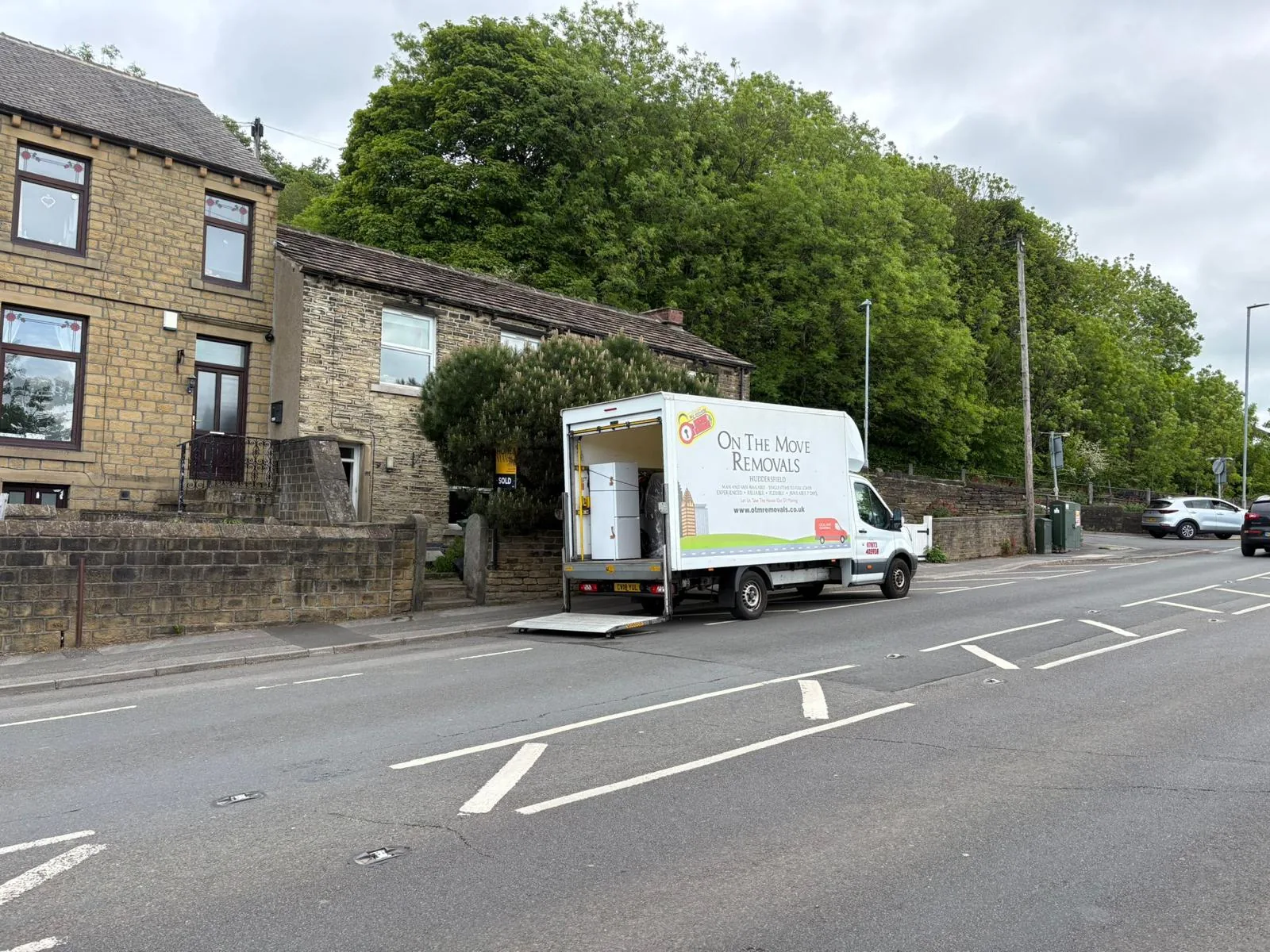 On The Move Removals Luton van outside stone terrace houses in Linthwaite, Huddersfield