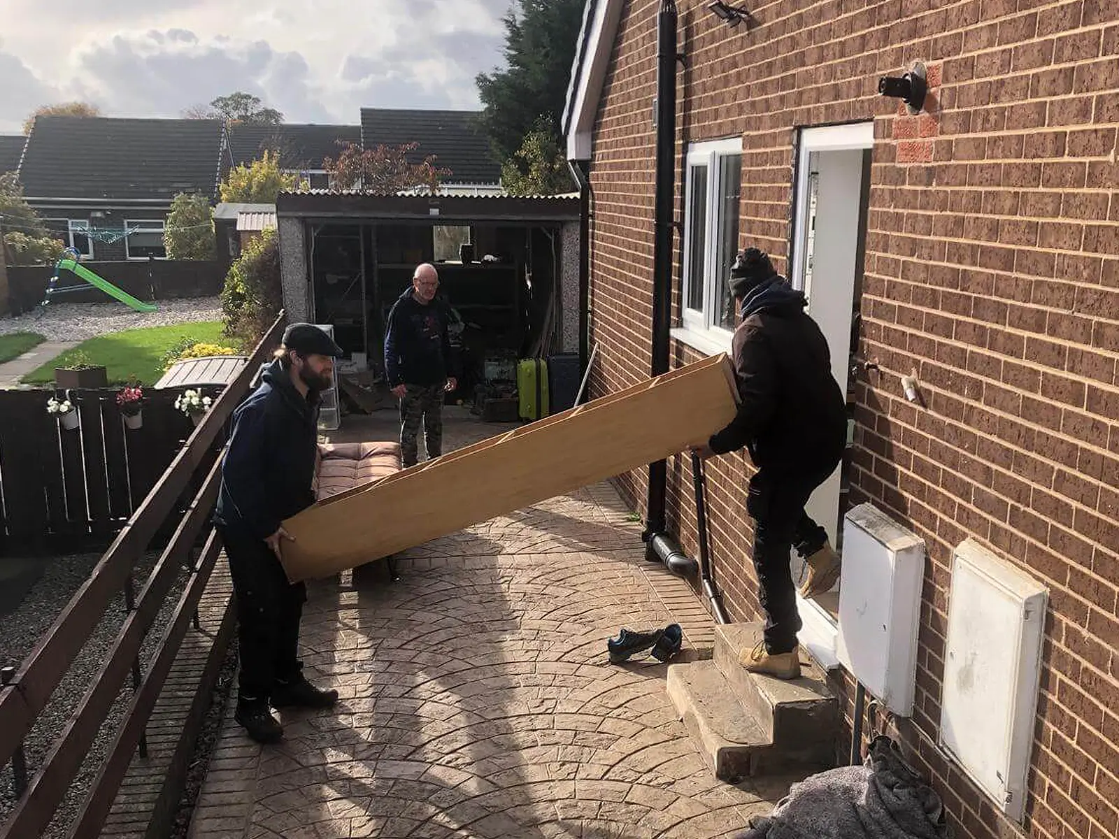 On The Move Removals team moving furniture out of a West Yorkshire home