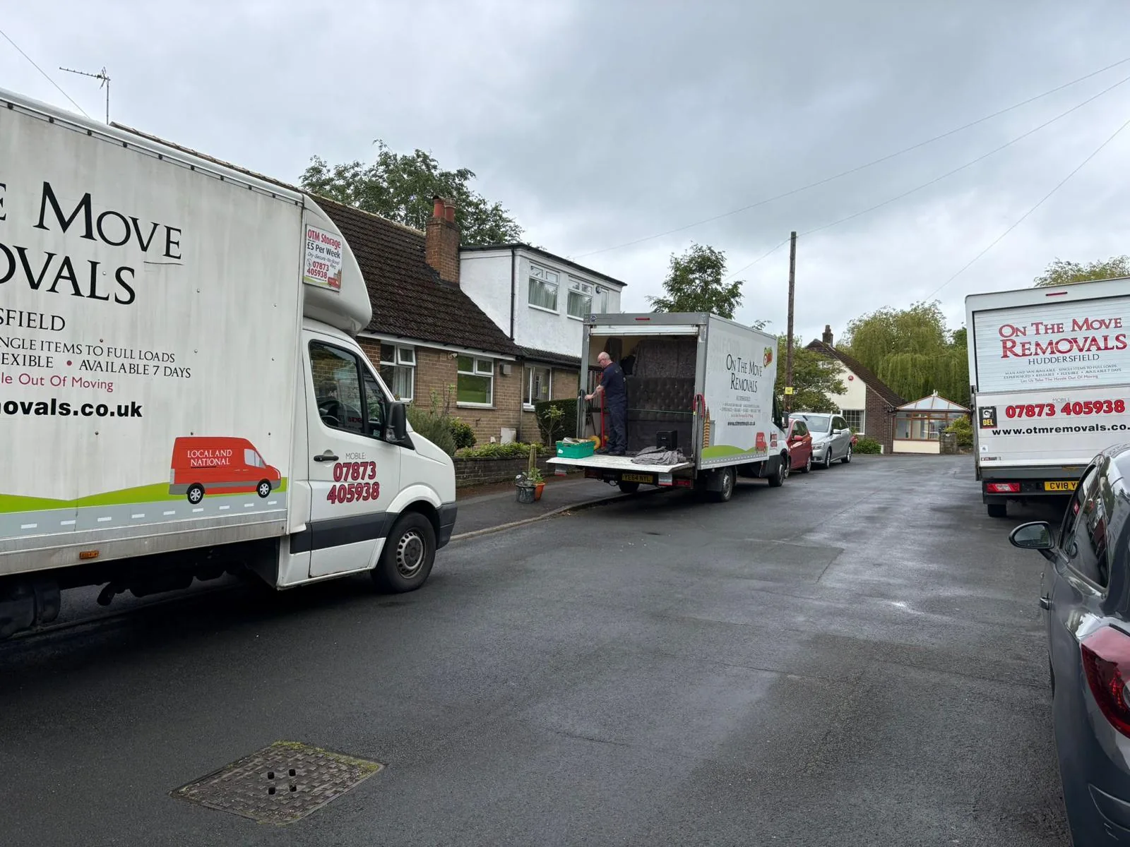 Two On The Move Removals vans on a residential street in Crosland Moor, Huddersfield