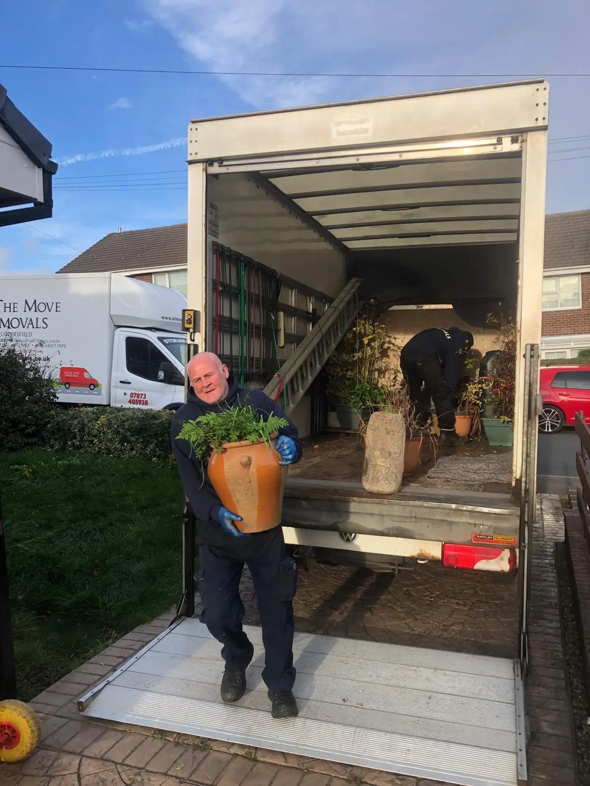 Shaun moving items into new home